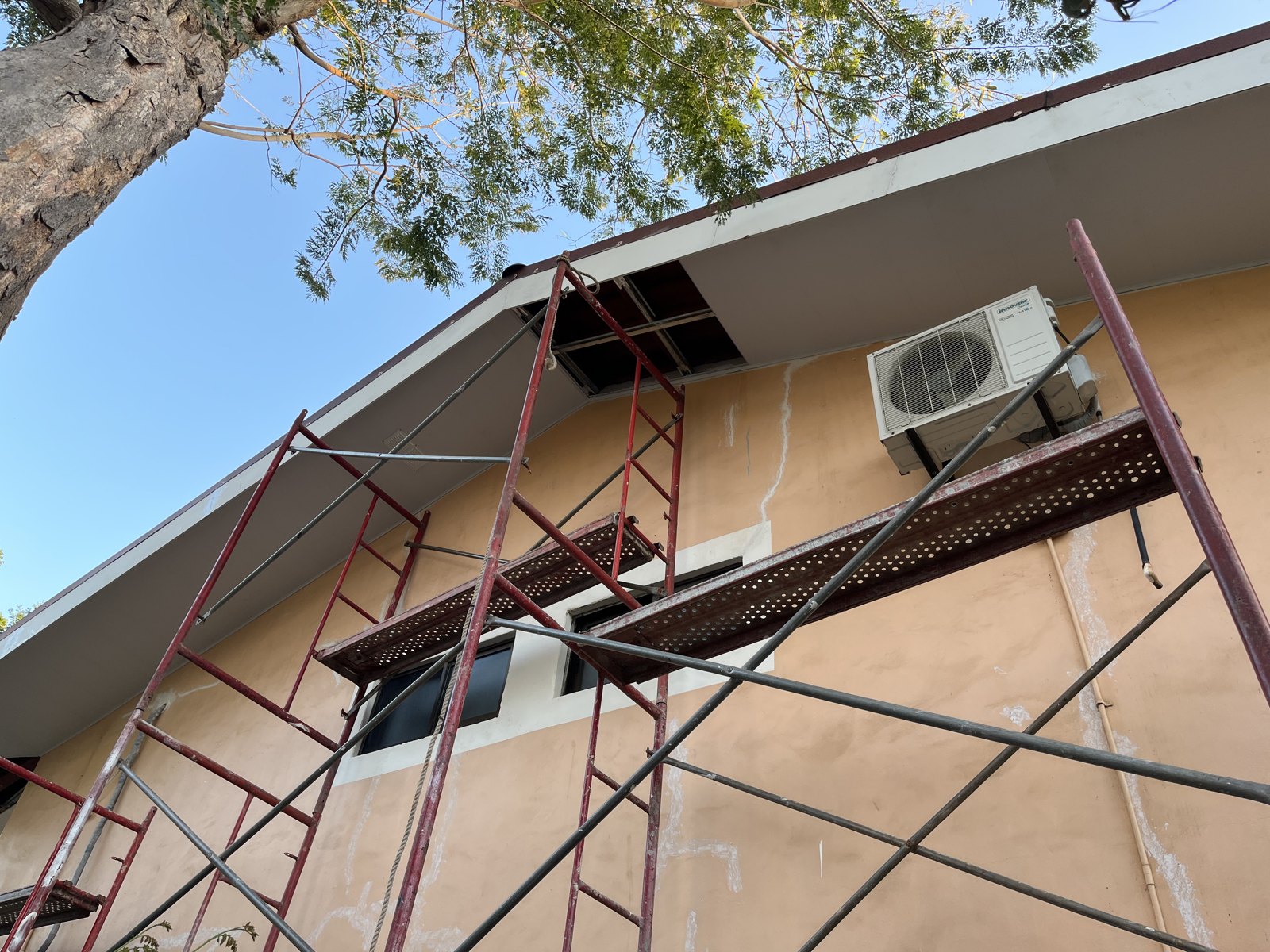 Scaffolding beside a house during exterior wall and soffit repairs